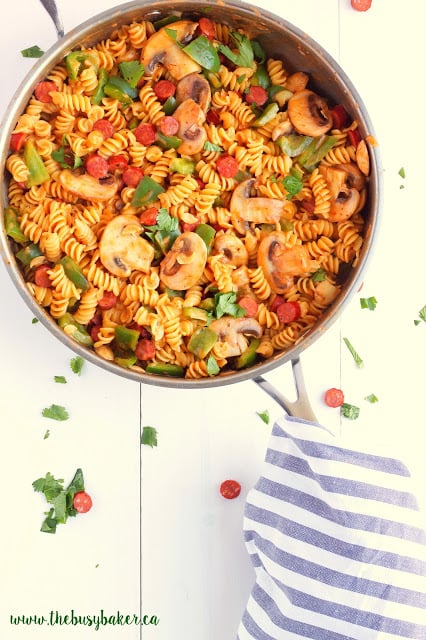 overhead image of a skillet meal made with rotini pasta, pepperoni and mushrooms