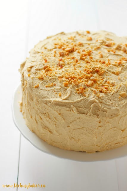 moist banana cake topped with fluffy peanut butter frosting and crushed peanuts