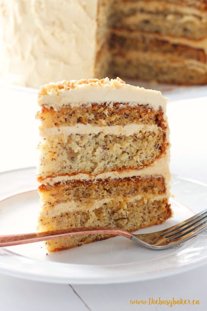 Banana Layer Cake with Fluffy Peanut Butter Frosting on a dessert plate with a fork