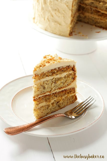 a slice of banana layer cake topped with peanut butter frosting