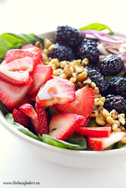 This healthy summer Berry Walnut Spinach Salad with Maple Vinaigrette is made with fresh spinach, berries and walnuts and an easy-to-make maple dressing! Recipe from thebusybaker.ca!