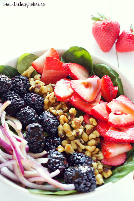 This healthy summer Berry Walnut Spinach Salad with Maple Vinaigrette is made with fresh spinach, berries and walnuts and an easy-to-make maple dressing! Recipe from thebusybaker.ca!