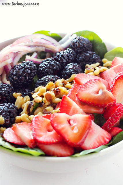 This healthy summer Berry Walnut Spinach Salad with Maple Vinaigrette is made with fresh spinach, berries and walnuts and an easy-to-make maple dressing! Recipe from thebusybaker.ca!