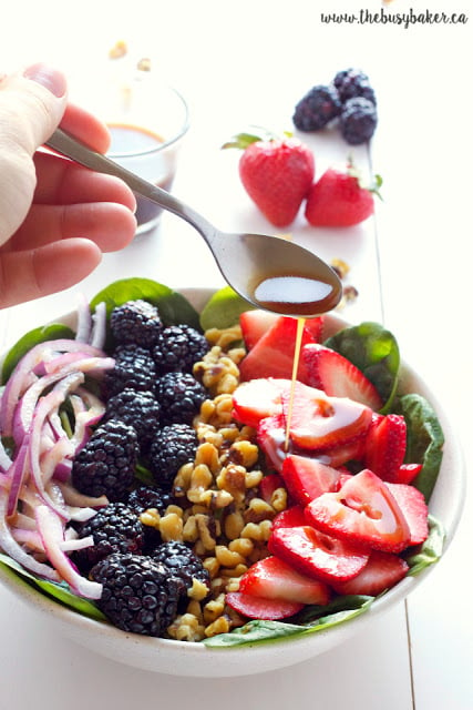 This healthy summer Berry Walnut Spinach Salad with Maple Vinaigrette is made with fresh spinach, berries and walnuts and an easy-to-make maple dressing! Recipe from thebusybaker.ca!