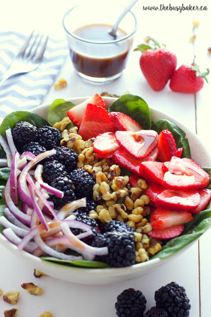 This healthy summer Berry Walnut Spinach Salad with Maple Vinaigrette is made with fresh spinach, berries and walnuts and an easy-to-make maple dressing! Recipe from thebusybaker.ca!