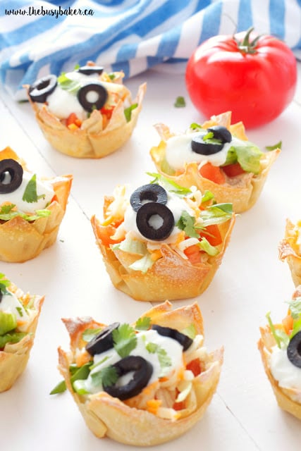 Mexican Taco Dip Wonton Cups topped with sliced black olives