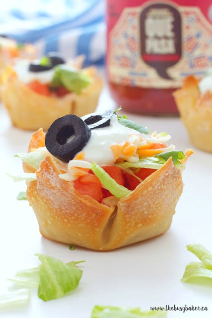 close up image of cold taco dip in a wonton cup