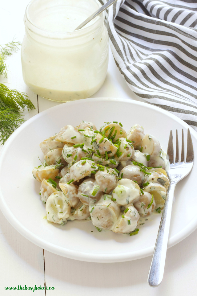 a white plate of healthier potato salad made with low fat buttermilk with a fork on the plate