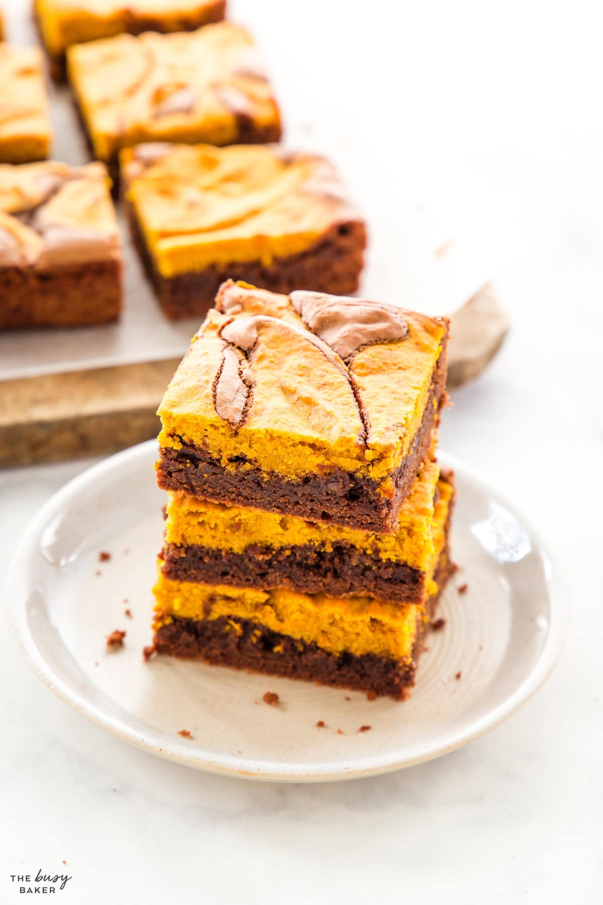 stack of 3 pumpkin swirl brownies on a plate