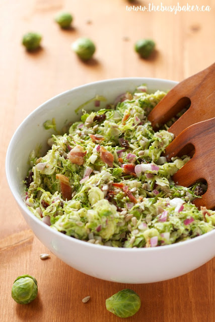shaved brussel sprouts salad in a white bowl