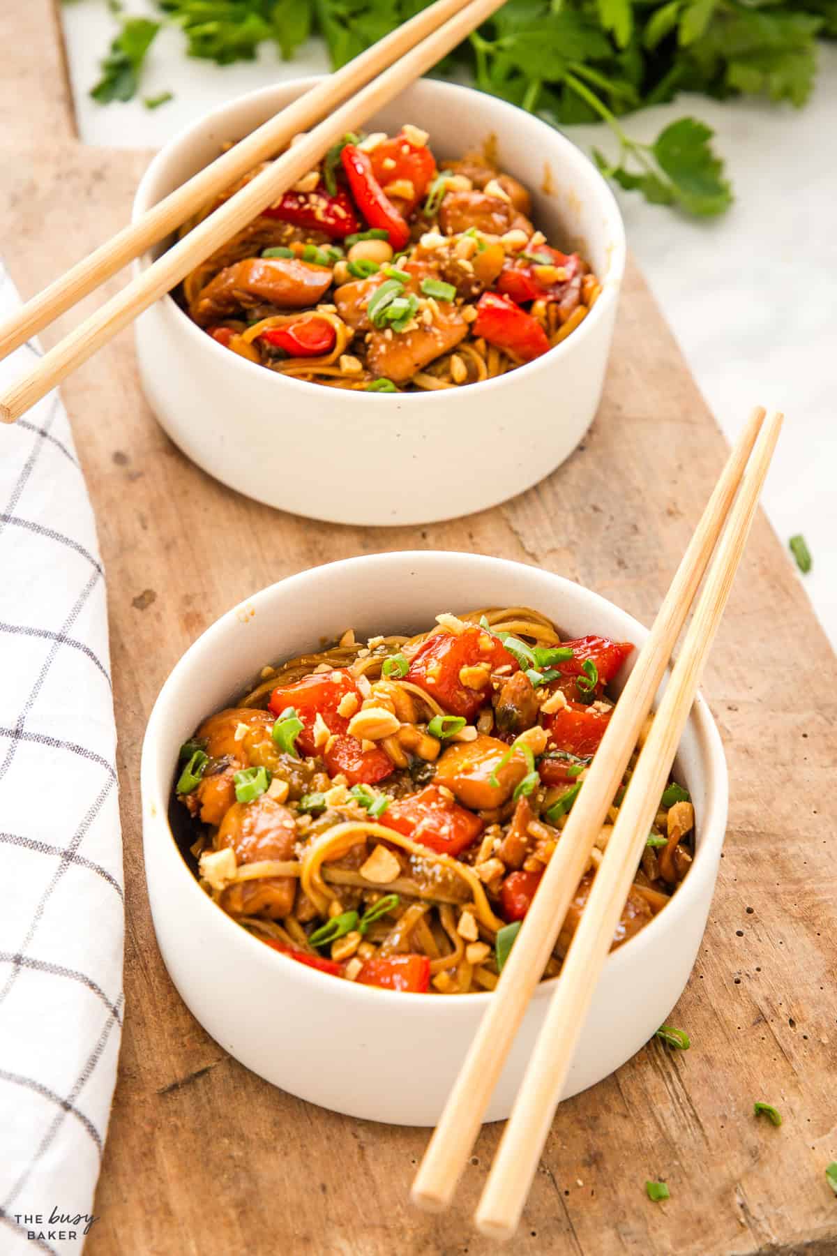 white bowl with kung pao chicken and noodles