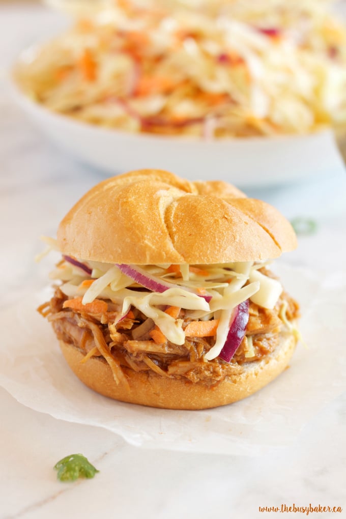 These Easy Slow Cooker Barbecue Pulled Pork Sandwiches feature a super easy 3-ingredient Slow Cooker Pulled Pork with an easy homemade coleslaw! Recipe from thebusybaker.ca!