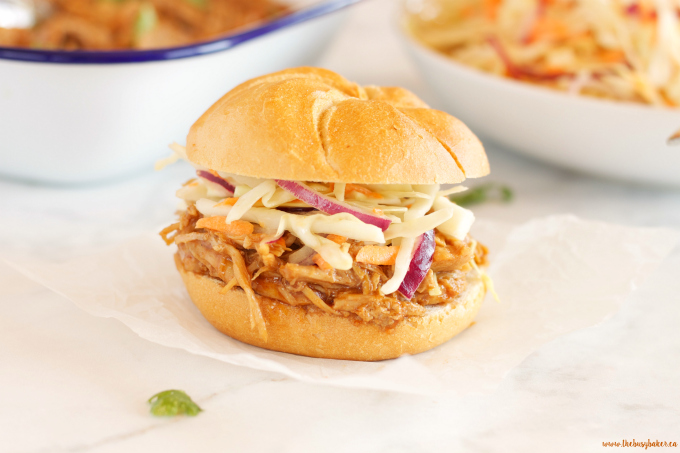 These Easy Slow Cooker Barbecue Pulled Pork Sandwiches feature a super easy 3-ingredient Slow Cooker Pulled Pork with an easy homemade coleslaw! Recipe from thebusybaker.ca!