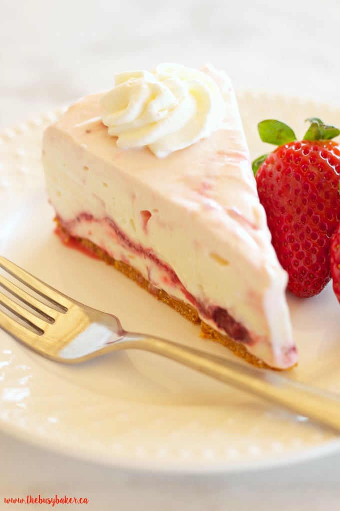 This Easy No Bake Strawberry Swirl Cheesecake is a delicious, easy to make, creamy and smooth dessert for spring and summer! And it's gelatin-free! Recipe from thebusybaker.ca!