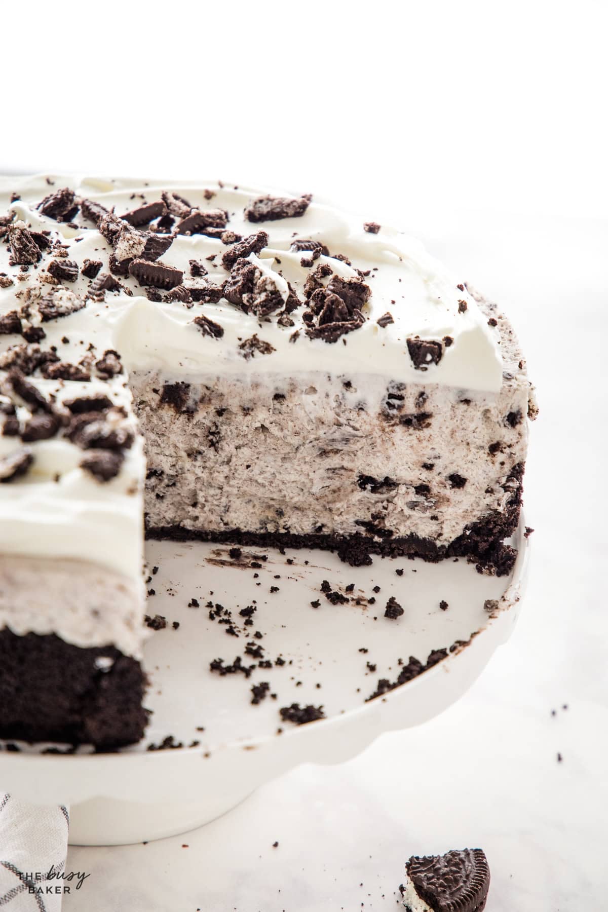 no bake oreo cheesecake with a creamy interior, whipped cream and crushed oreos