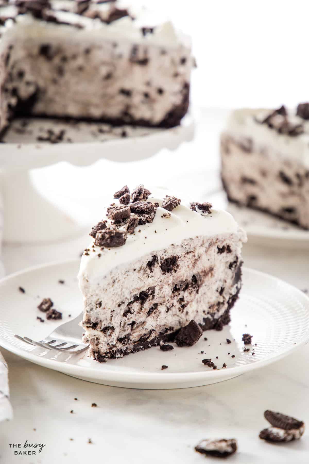 slice of creamy no bake oreo cheesecake on a white plate with a fork