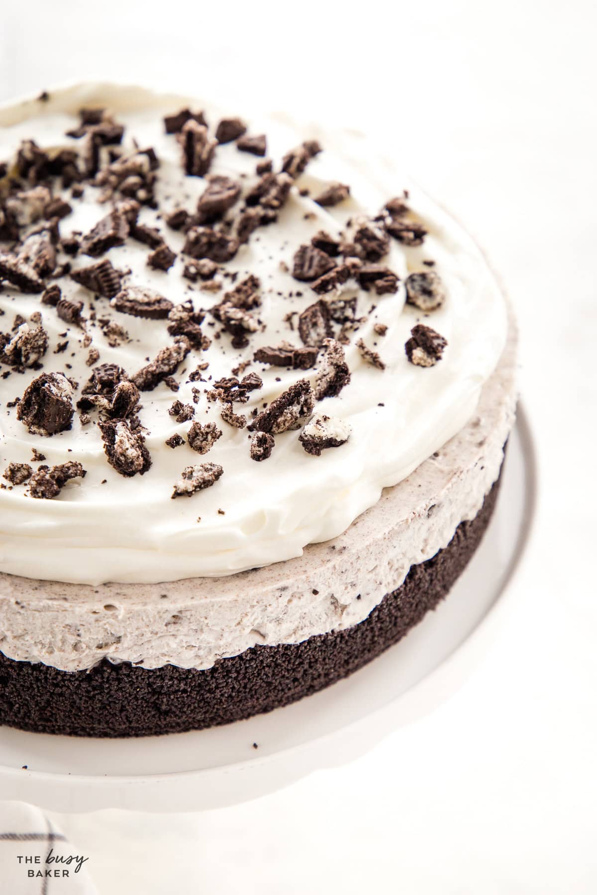 no bake oreo cheesecake with whipped cream and crushed oreos