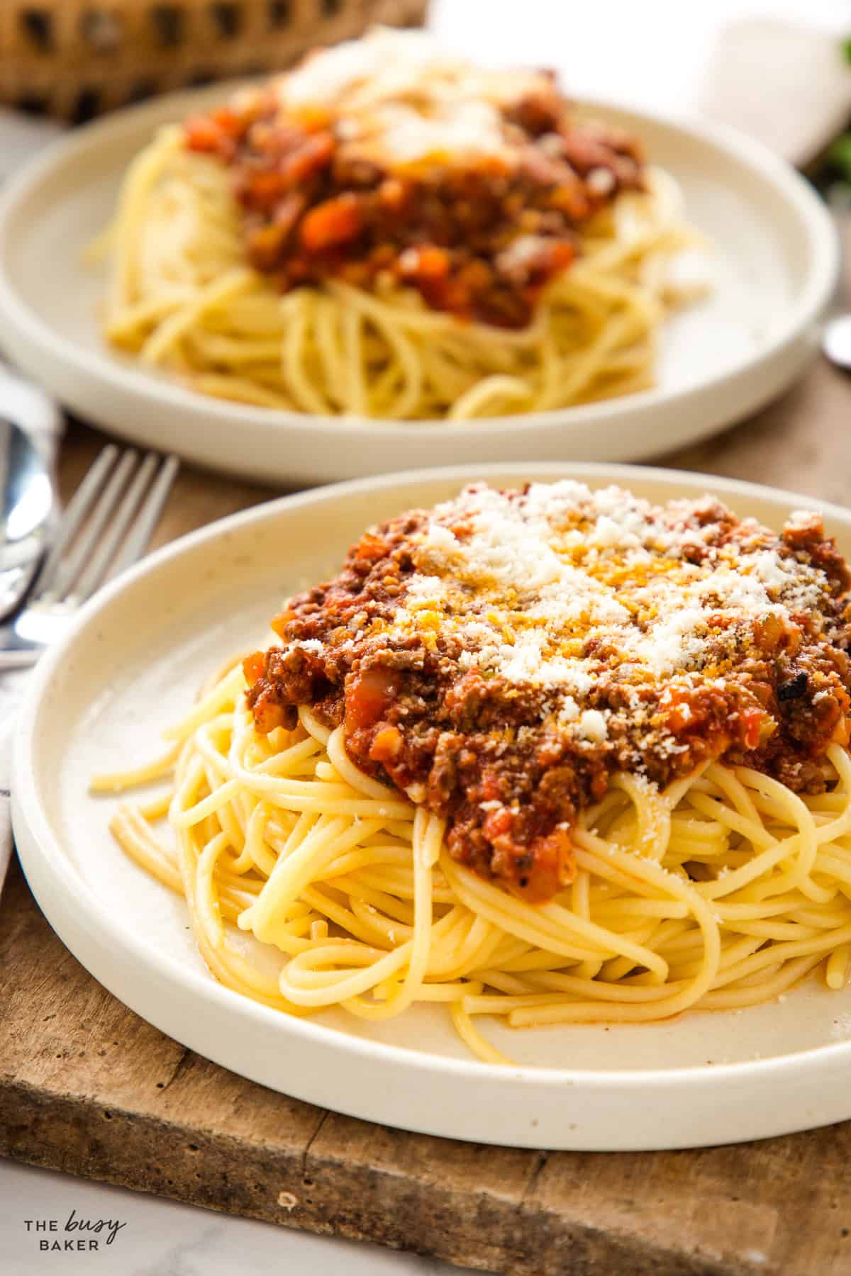 plate of spaghetti with meat sauce and parmesan cheese