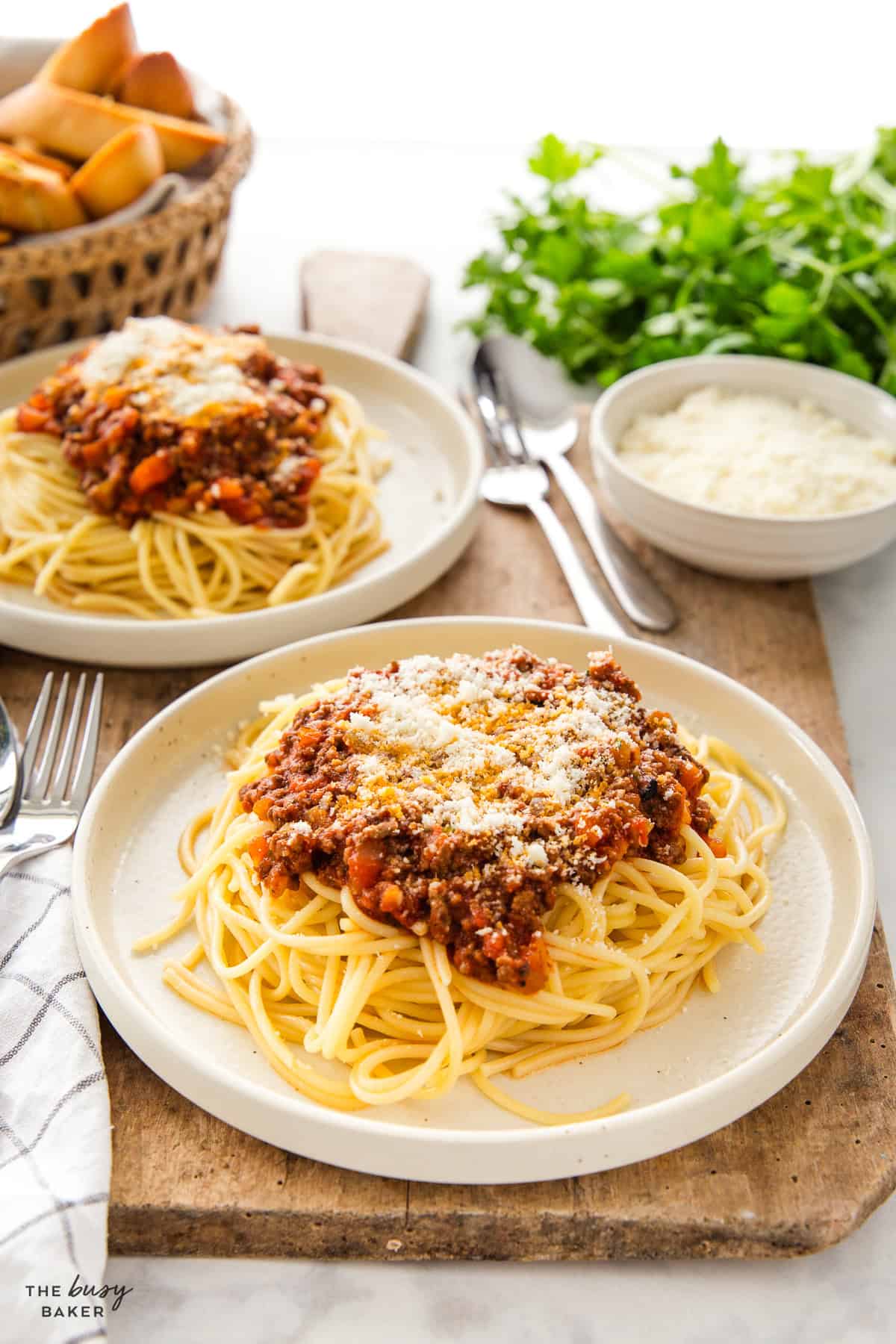 plates of spaghetti with meat sauce and parmesan cheese