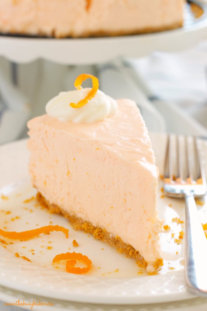 close up image of a large slice of orange cheesecake 