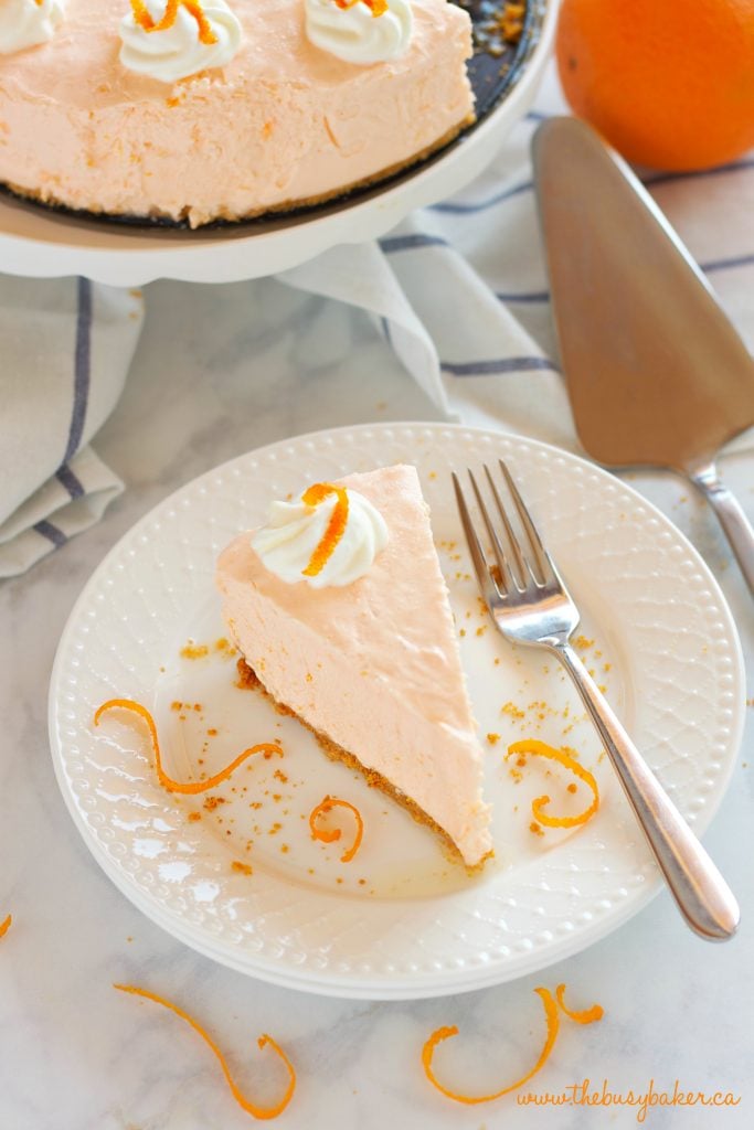 orange cheesecake slice on a white plate