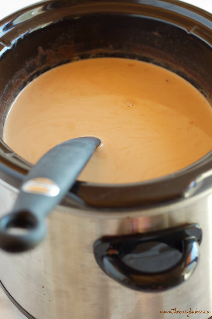 This Slow Cooker Pumpkin Spice Latte is the perfect warm fall drink with everybody's favorite pumpkin spice flavors - it's easy to make in the Crock Pot or slow cooker, and it's great for parties! Recipe from thebusybaker.ca!