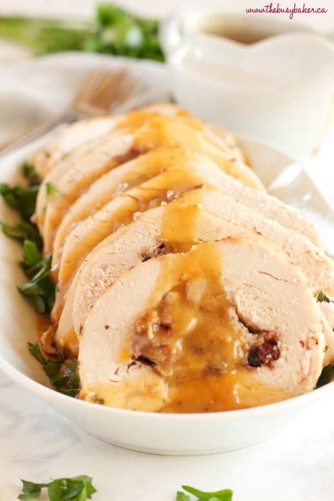 This Roasted Turkey Breast with Cranberry Bacon Stuffing is an easy holiday recipe! Juicy turkey and easy homemade stuffing with cranberries, bacon & herbs! Perfect for Thanksgiving or Christmas for a small holiday dinner crowd! Recipe from thebusybaker.ca! #christmasturkey #thanksgivingturkey #easythanksgivingrecipe #easyturkeyrecipe