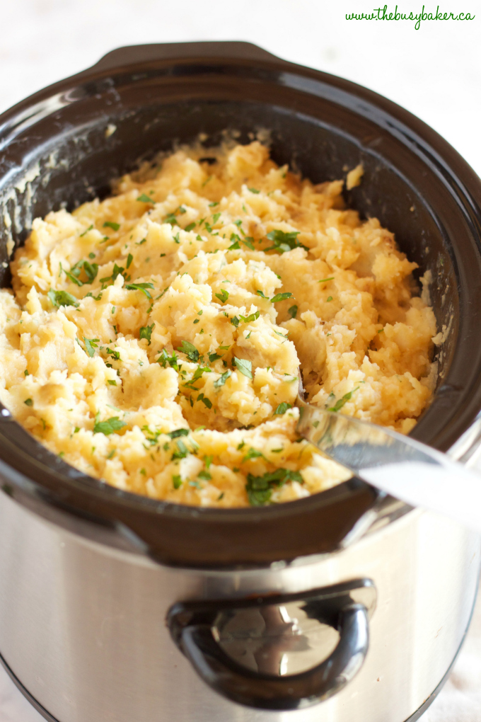 These Rustic Slow Cooker Garlic Mashed Potatoes are a delicious easy to make holiday side dish that's perfect for any holiday crowd! Recipe from thebusybaker.ca! #holidaysidedish #holidaymashedpotatoes #christmassidedish