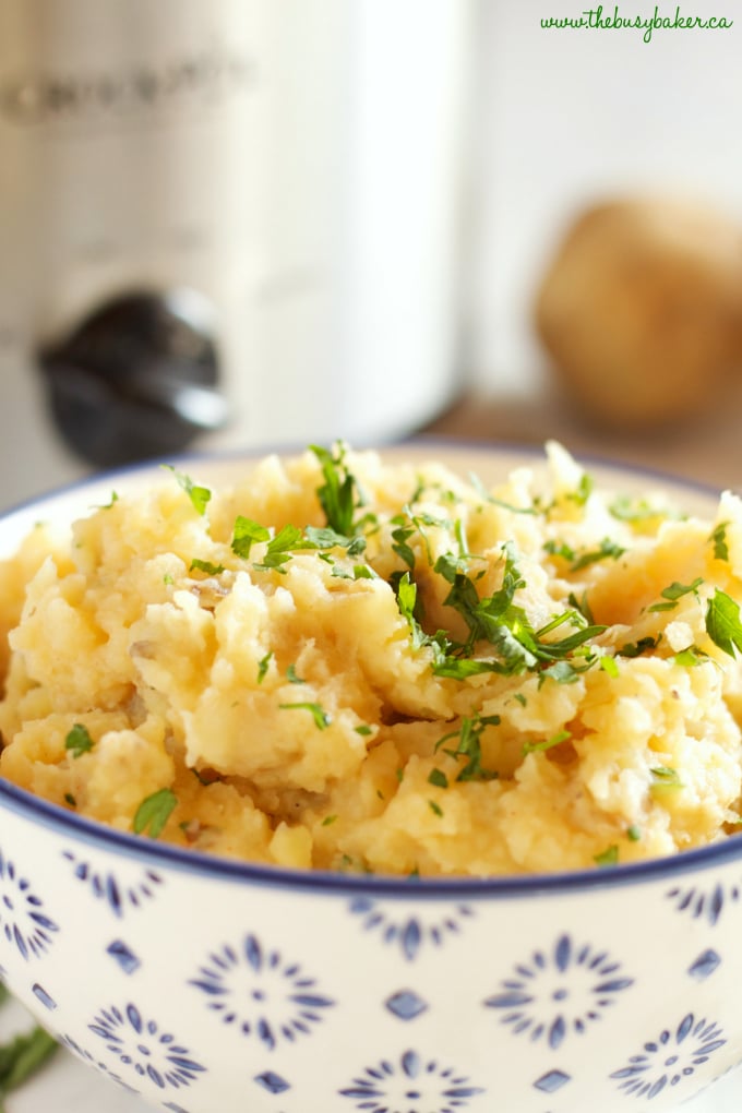 These Rustic Slow Cooker Garlic Mashed Potatoes are a delicious easy to make holiday side dish that's perfect for any holiday crowd! Recipe from thebusybaker.ca! #holidaysidedish #holidaymashedpotatoes #christmassidedish