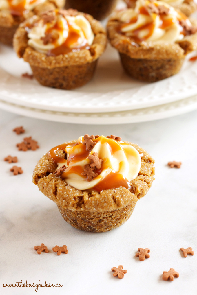 These Gingerbread Cookie Cups with Pumpkin Cheesecake Filling the perfect holiday dessert made with soft gingerbread, pumpkin cheesecake and caramel! Recipe from thebusybaker.ca! #caramelcookies #gingerbreadcookies #christmascookies #gingerbreadpumpkincookies