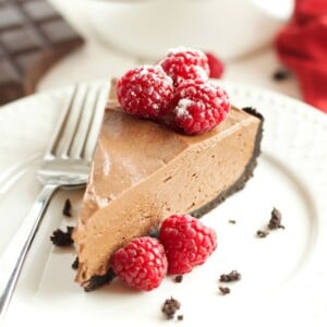 vegan chocolate mousse cheesecake with red raspberries on top