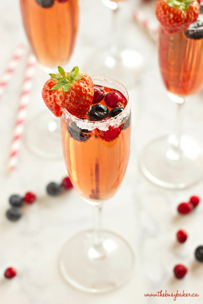 This Sparkling Winter Berry Holiday Cocktail is the perfect drink recipe for holiday parties! It's bursting with winter flavours, and it's so easy to make! Recipe from thebusybaker.ca #holidaycocktail #holidaymocktail #holidaypunch #christmasdrink