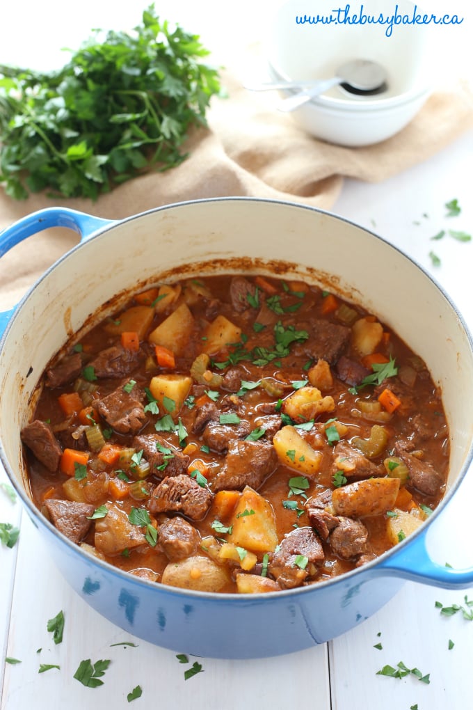 crock pot beef stew in a blue dutch oven pot