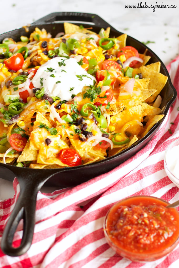 Vegetarian Nachos with salsa and sour cream in skillet