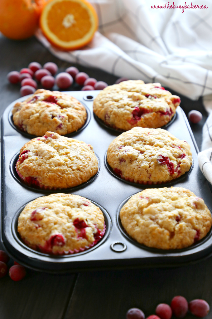These Cranberry Orange Muffins are packed with tart cranberries and zesty orange flavour and they make the perfect sweet treat or snack! They're the perfect recipe for beginning bakers because they're easy to make with simple ingredients! Recipe from thebusybaker.ca! #cranberryorangemuffins #easymuffinrecipe