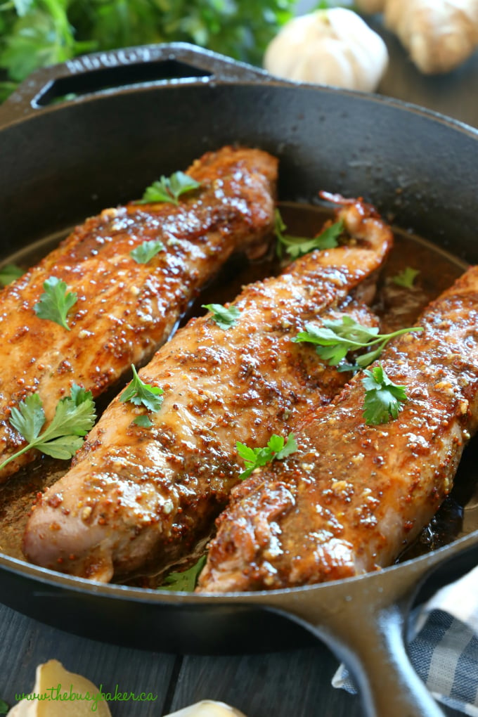 This Easy One Pan Sweet Ginger Glazed Pork Tenderloin is perfectly tender and juicy, cooked to perfection with a sweet ginger glaze! Made from basic ingredients you probably already have in your kitchen, this will quickly become one of your favourite ways to enjoy pork! Recipe from thebusybaker.ca! #easyporktenderloin #asianpork #gingerglazedpork