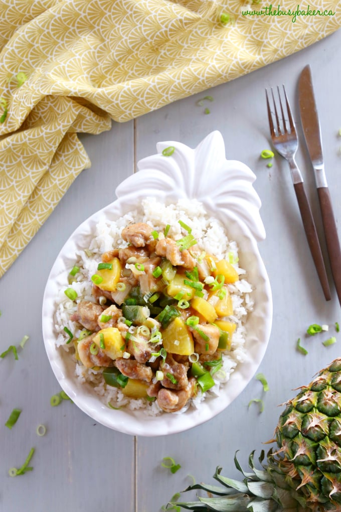 These Pineapple Chicken Rice Bowls make the perfect healthy easy weeknight meal! Made with crispy chicken, fresh veggies, pineapple and a sweet Asian-inspired sauce, they're on the table in 25 minutes or less! Recipe from thebusybaker.ca! #pineapplechicken #easychickenrecipe #pineapplechickenstirfry #asianchicken
