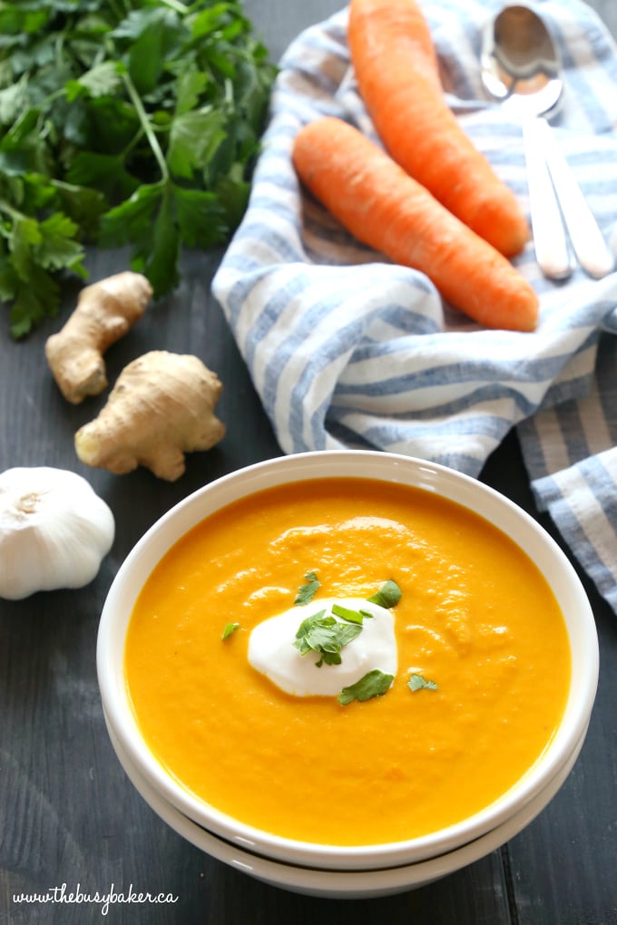 This Slow Cooker Creamy Carrot Ginger Soup is the easiest carrot soup that's warm, hearty, and packed with spicy ginger and creamy coconut. It's healthy, made with only a few simple ingredients, and it's so easy to make in the Crock Pot or slow cooker!! Recipe from thebusybaker.ca! #slowcookersoup #dairyfreesoup