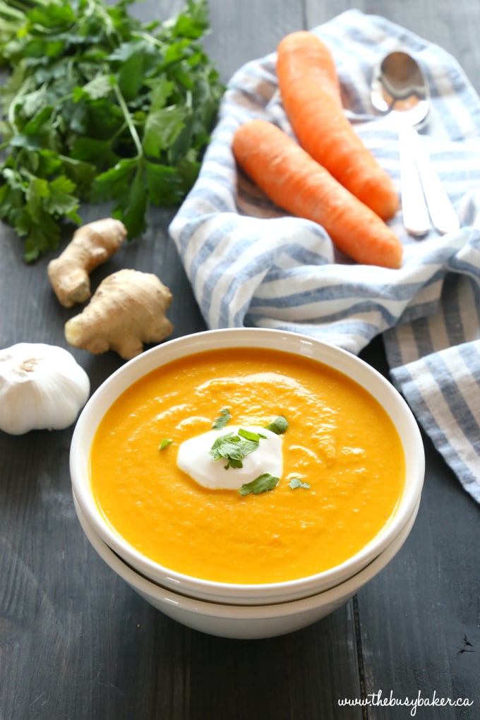 This Slow Cooker Creamy Carrot Ginger Soup is the easiest carrot soup that's warm, hearty, and packed with spicy ginger and creamy coconut. It's healthy, made with only a few simple ingredients, and it's so easy to make in the Crock Pot or slow cooker!! Recipe from thebusybaker.ca! #slowcookersoup #dairyfreesoup