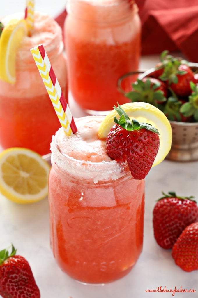 Healthy Strawberry Lemonade drink with lemons and straws