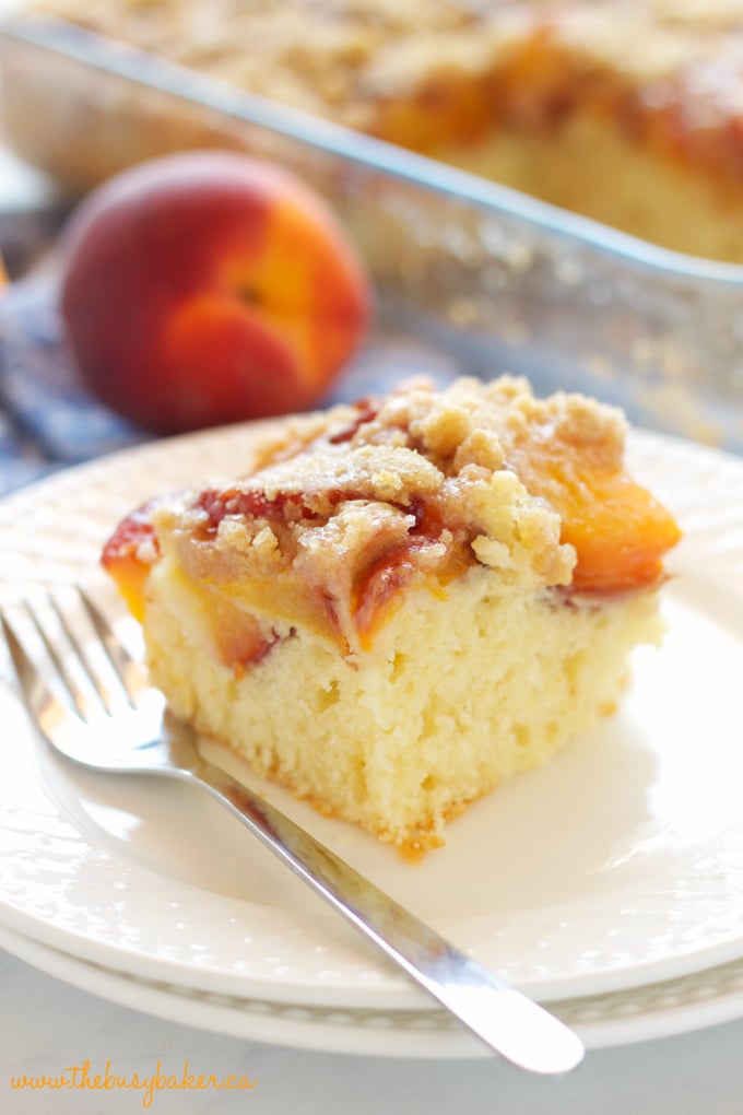 Peach Streusel Cake with fresh peaches on white plate with fork