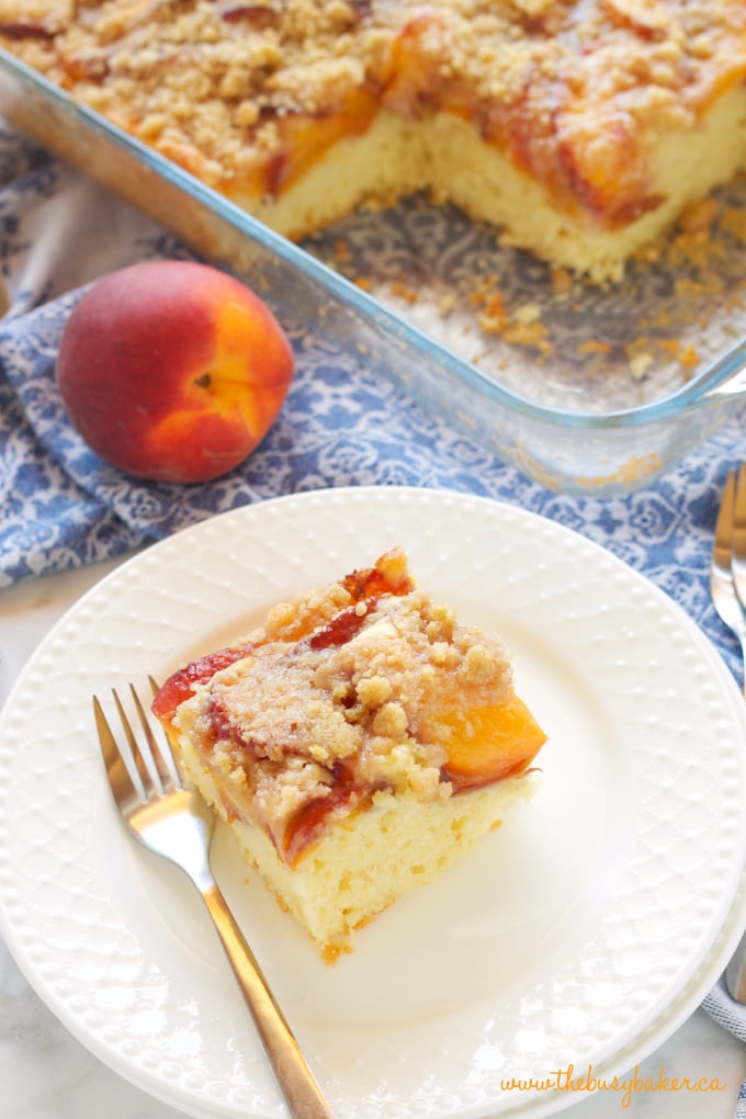 Peach Streusel Cake with blue fabric and fresh peach