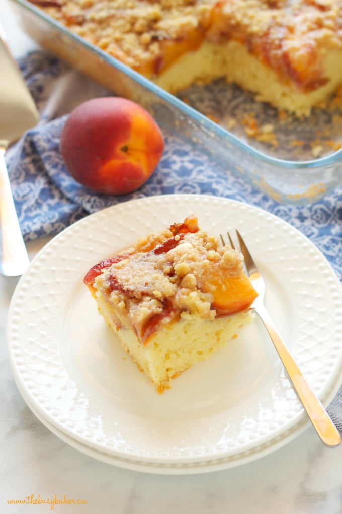 Peach Streusel Cake with cake pan and white plate with fork