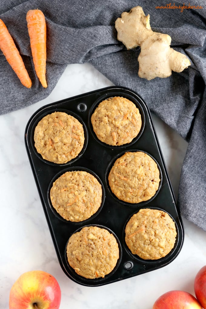 Apple Carrot Muffins in muffin tin with apples and ginger root