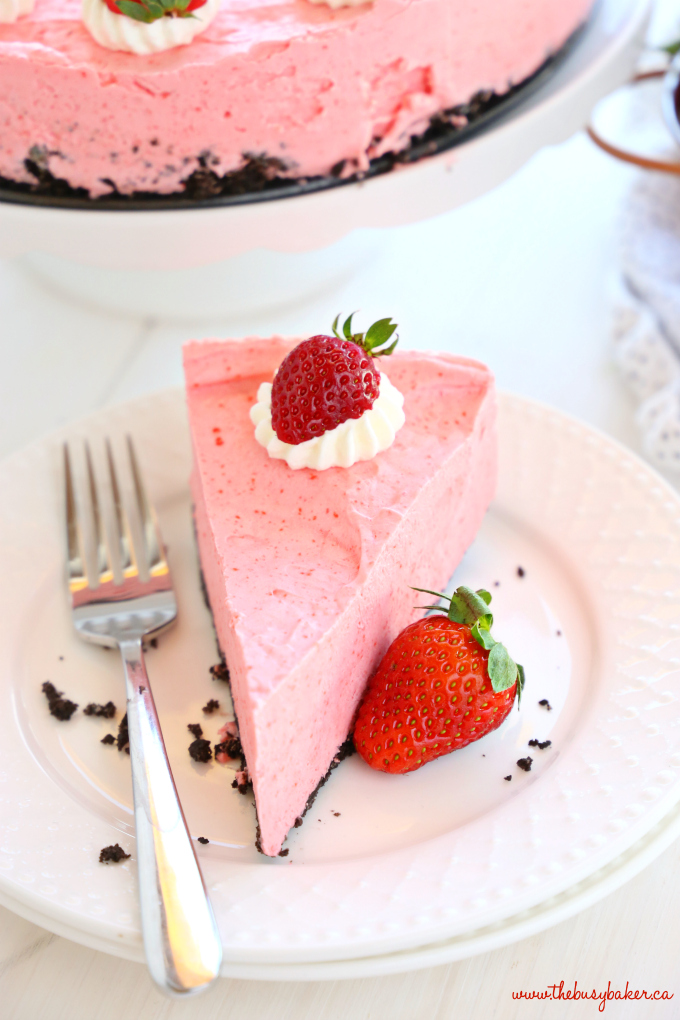 Easy No Bake Strawberry Cheesecake with whipped cream and strawberries