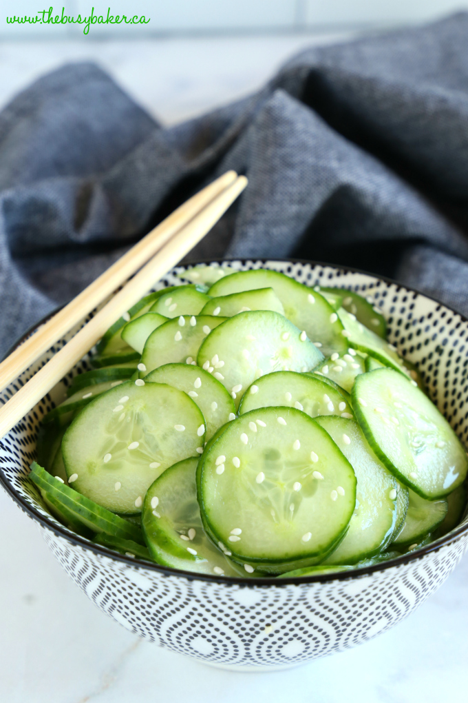 Easy Asian Cucumber Salad in black and white bowl with chopsticks