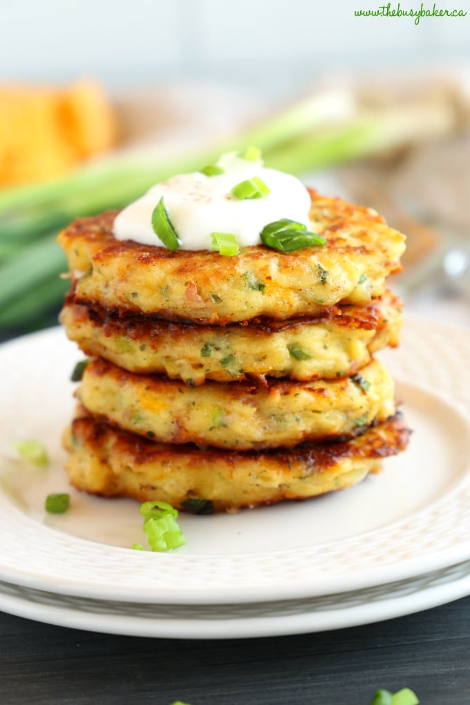 Stack of Cheesy Leftover Mashed Potato Pancakes on white plates