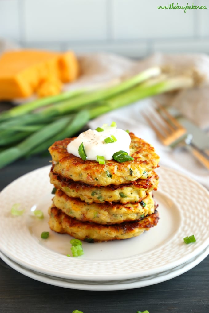 Cheesy Leftover Mashed Potato Pancakes with cheese and green onions and sour cream on plate