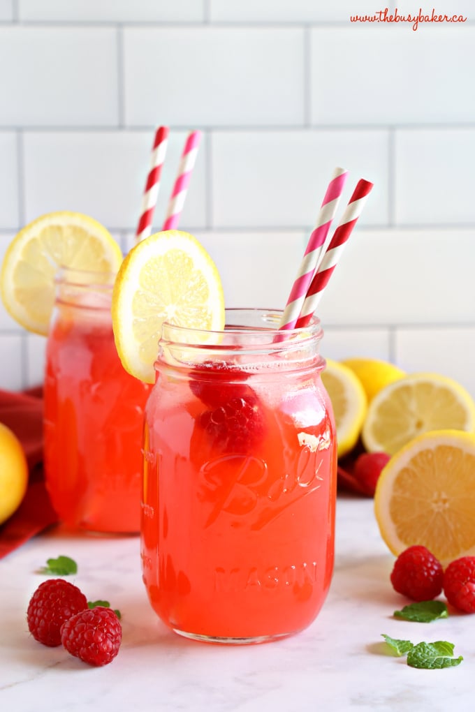 Easy Healthy Raspberry Lemonade with paper straws and lemon slices