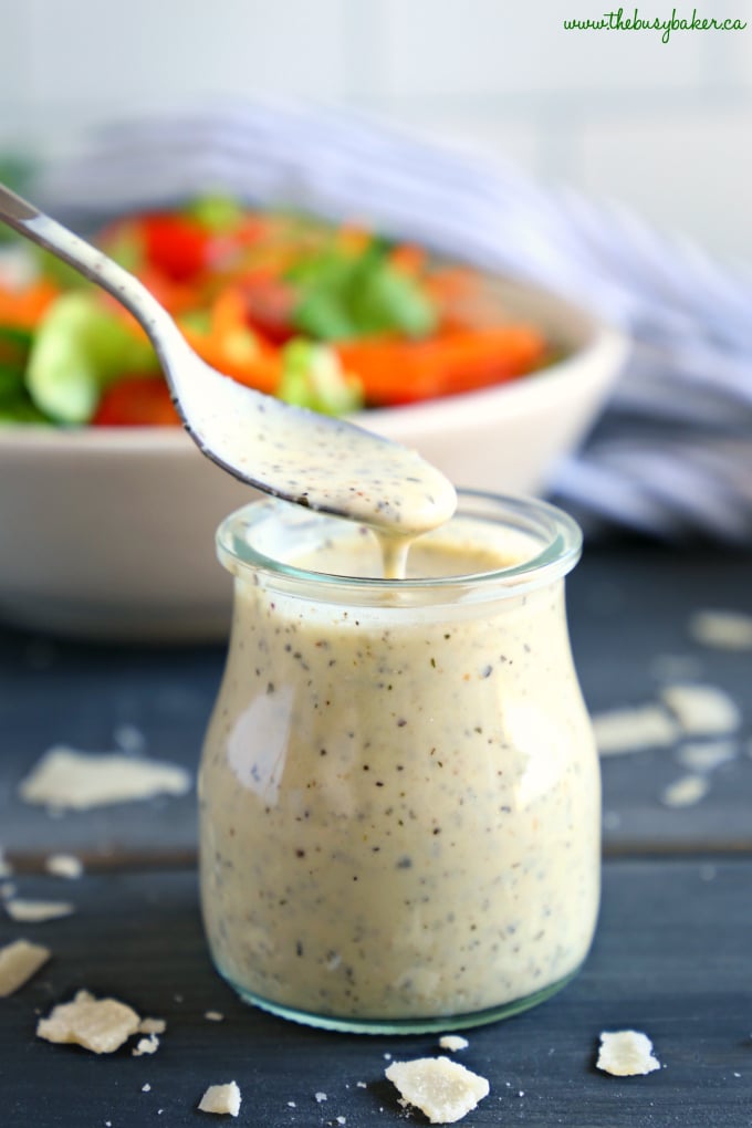 Classic Creamy Italian Salad Dressing in jar with salad in background